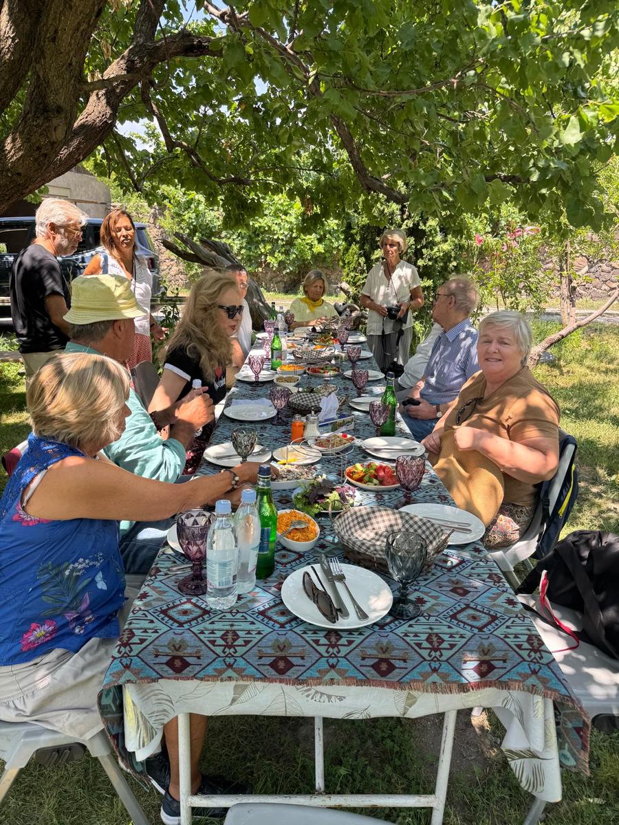 Almoço do grupo numa mesa comprida debaixo de uma árvore